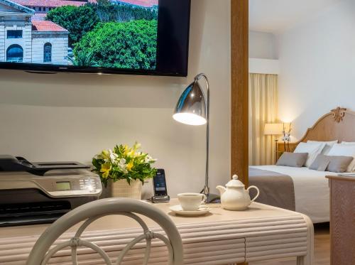 a hotel room with a bed and a table with a table sidx sidx at Kydon The Heart City Hotel in Chania Town