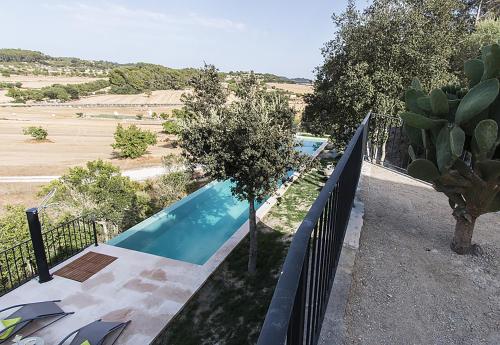 a swimming pool in a yard with a fence at Country House Sa Serra in Lloret de Vistalegre