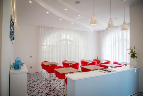 a room with red chairs and tables and a counter at Palazzo San Giovanni Amalfi Coast in Scala