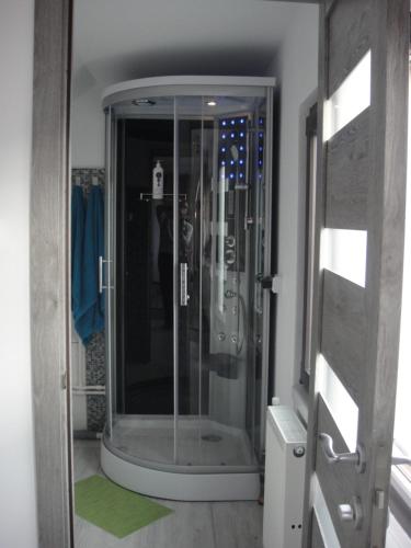 a shower with a glass door in a bathroom at Rasnov Retreat in Râşnov