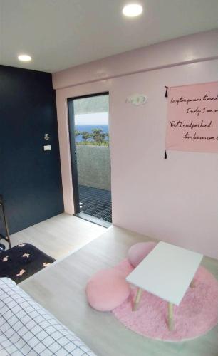 a room with a bench and a sign on the wall at Top Sunlight Inn in Xiaoliuqiu