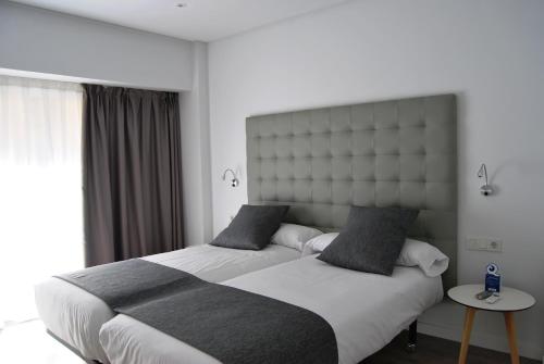 Ένα ή περισσότερα κρεβάτια σε δωμάτιο στο Estudiotel Alicante