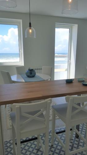 a dining room with a table and two chairs at The Shore @ BaíaBeach - Waterfront in Espinho