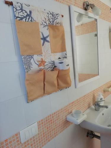 a bathroom with two towels hanging on the wall at Hotel Noto Marina Stella Marina - B&B in Noto Marina