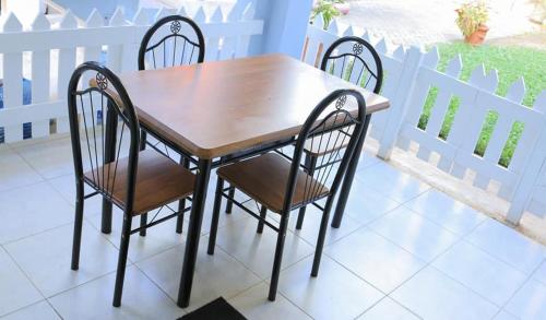 a wooden table and chairs on a patio at Serene Homes in Mombasa