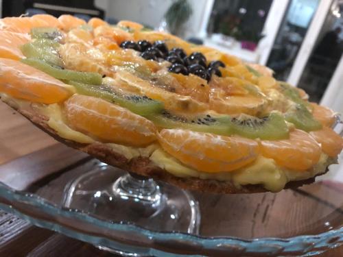 a fruit tart on a glass plate on a table at Boutique Hotel Palazzo Corso Umberto in Boiano