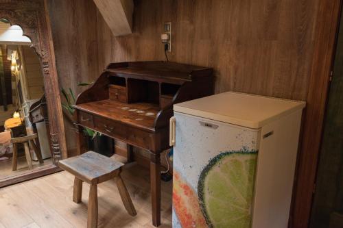 Luna del Valle في نويفا دي يانس: مكتب قديم وطاولة وثلاجة في الغرفة