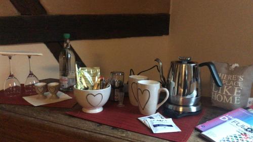 a counter with coffee makers and cups on it at McMüller's Kemenate Fulda in Fulda