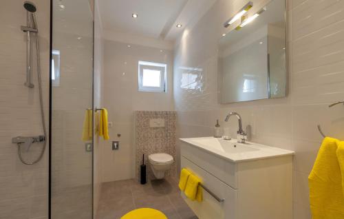 a bathroom with a sink and a toilet and a shower at Olive Tree apartments in Podstrana