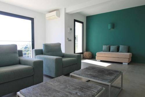a living room with a couch and a chair and a table at Villa Wivine in Moraira