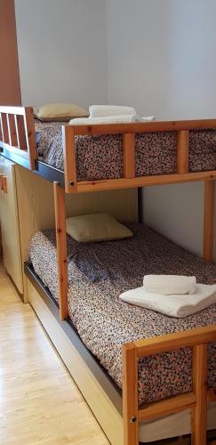 a room with three bunk beds in a room at Soldeu Paradis Soldeu in Soldeu