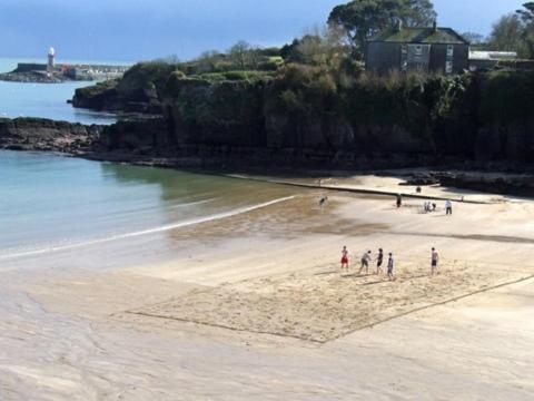 a group of people standing on a beach at The Strand Inn in Dunmore East