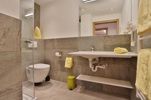 a bathroom with a toilet and a sink at Arvenhof in Serfaus