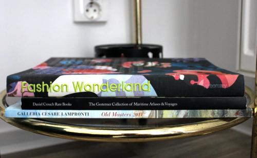 a stack of books sitting on a table at Happy Holiday Apartments in Predeal