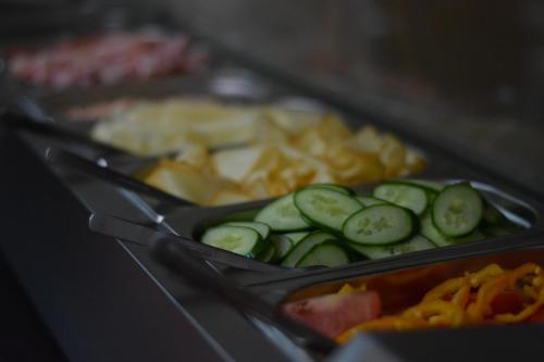 two trays of food with cucumbers and chips at Penzion u Bednářů in Pavlov