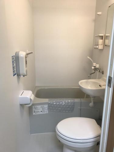 a bathroom with a toilet and a sink at Nono teru Narita in Narita