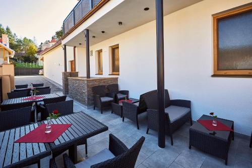 a restaurant with tables and chairs on a patio at Penzion U Zámku in OÅ™echov