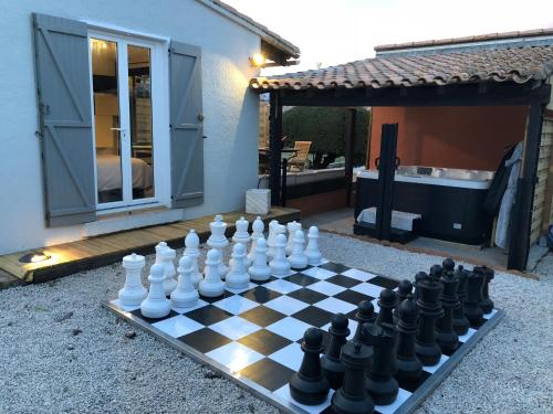a chess board sitting on top of a yard at La chambre des Onglous in Marseillan