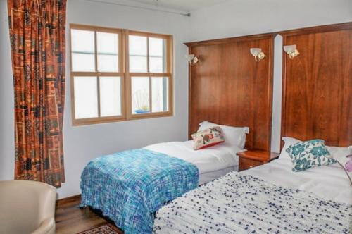 a hotel room with two beds and a window at The Nore River House in Kilkenny