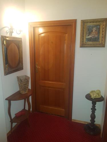 a room with a wooden door and a table at Willa Marysin in Maków Podhalański