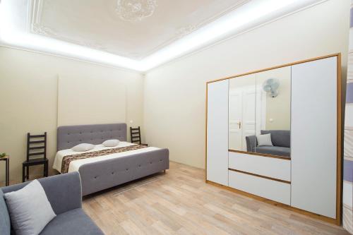 a bedroom with a bed and a large mirror at Modern Apartment Navratilova 16 in Prague