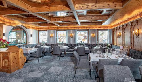 a restaurant with tables and chairs in a room at Hotel Hubertus in Sölden