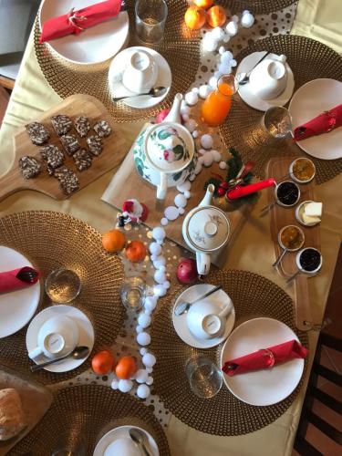 a table with white plates and fruit on it at Agriturismo Lemire in San Pietro di Feletto