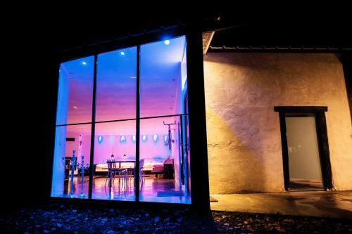 a room with a table and a window with a sunset at La grange des Palles in Vijon