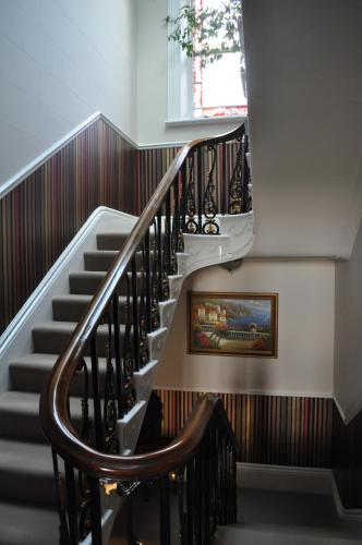 a stairway with a stair case and a window at Aberley House in Liverpool