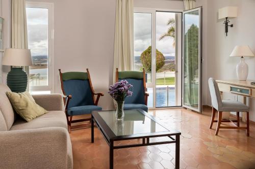 a living room with a couch and chairs and a table at Parador de Ayamonte in Ayamonte