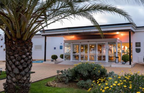 a palm tree in front of a building at Parador de Ayamonte in Ayamonte