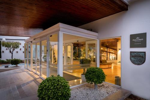 a building with glass doors and plants in it at Parador de Ayamonte in Ayamonte