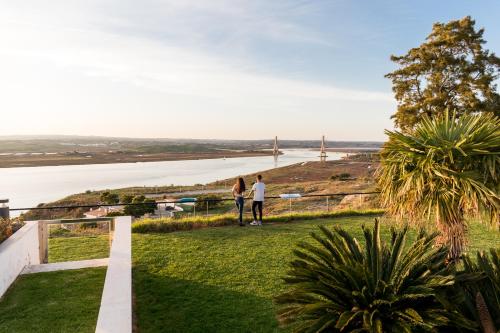 two people standing on a hill overlooking the water at Parador de Ayamonte in Ayamonte