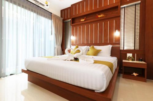 a bedroom with a large white bed in a room at The Scene Cliff View Villas in Ao Nang Beach