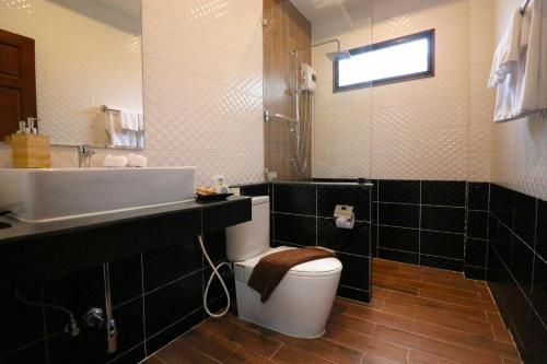 a bathroom with a white toilet and a sink at The Scene Cliff View Villas in Ao Nang Beach