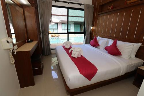 a bedroom with a bed with a stuffed elephant on it at The Scene Cliff View Villas in Ao Nang Beach