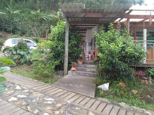 a house with a wooden walkway leading to a porch at Casa finca El Girasol in Guayabal de Síquima