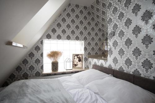 a bedroom with a large bed and a window at Apartamenty Ciche Wzgórze Zakopane in Zakopane