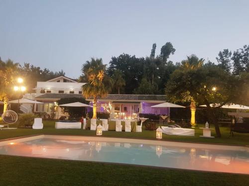 a swimming pool in front of a house at night at Parco d'Arte AltArt in Rende