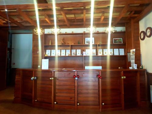 a wooden cabinet in a room with lights at Saint Ivan Ski Apartments in Bansko