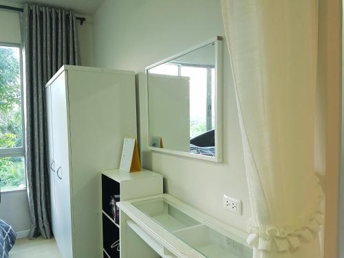 a bathroom with a mirror and a white dresser at Dcondo Kathu Patong Phuket by Suna in Kathu