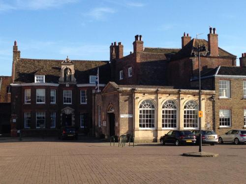 a large brick building with cars parked in front of it at Bank House in King's Lynn