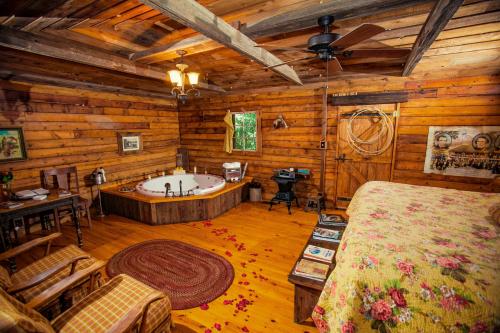 a bedroom with a tub in a log cabin at 7F Lodge and Events in College Station