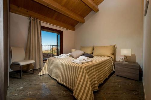 a bedroom with a large bed with a window at Villa Thalia in Castellammare del Golfo