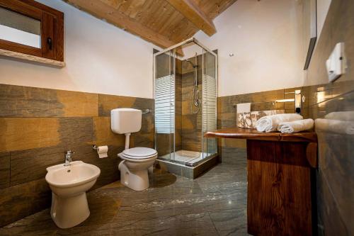 a bathroom with a toilet and a glass shower at Villa Thalia in Castellammare del Golfo