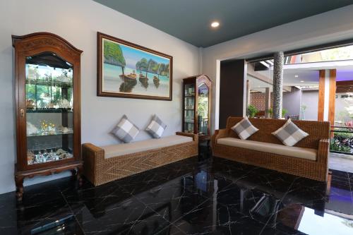 a living room with two couches and two windows at The Scene Cliff View Villas in Ao Nang Beach