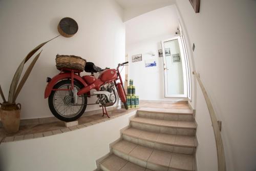 a red motorcycle hanging on a wall in a hallway at Blue And Blue City in Ugento