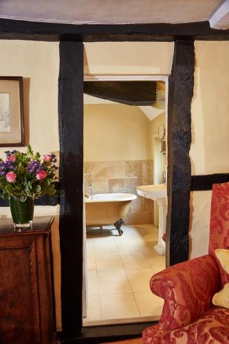 a bathroom with a bath tub and a sink at Spread Eagle Hotel And Spa in Midhurst