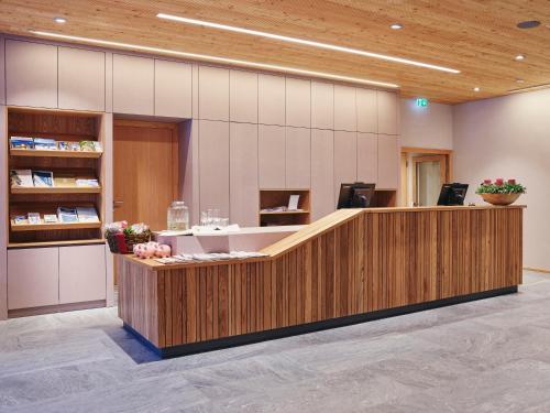 a lobby with a reception desk in a hospital at Kinderhotel Stegerhof in Donnersbachwald