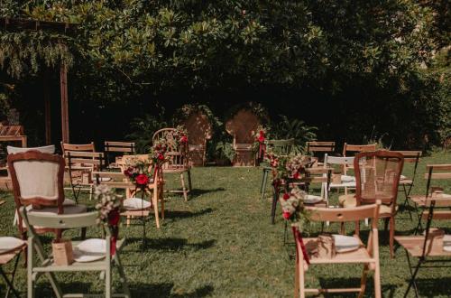 a row of chairs and tables with flowers on the grass at Hotel Rio Bidasoa in Hondarribia